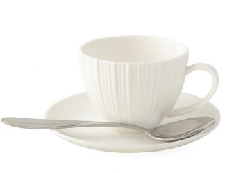 White ceramic teacup with spoon on matching saucer.