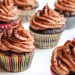 Chocolate cupcakes topped with rich frosting in colorful wrappers.