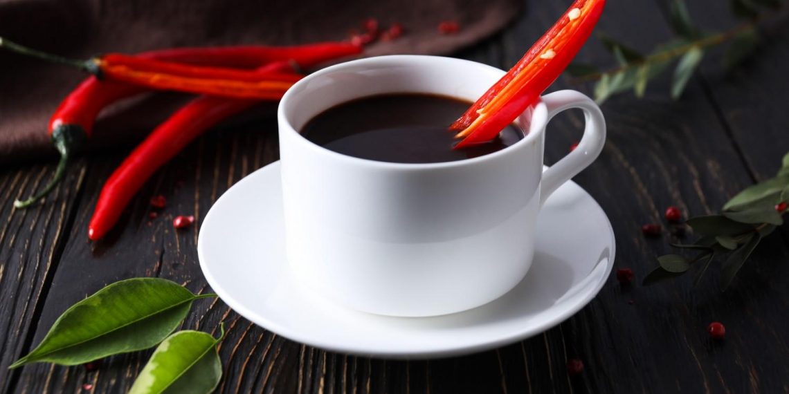 Spicy hot chocolate with a red chili garnish.