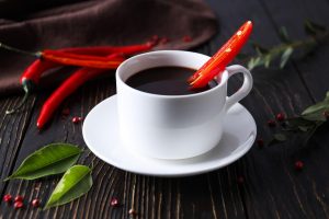 Spicy hot chocolate with a red chili garnish.