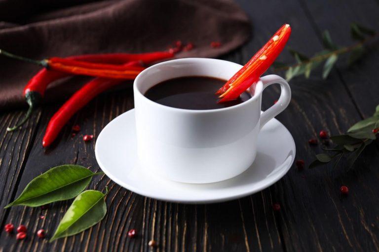 Spicy hot chocolate with a red chili garnish.