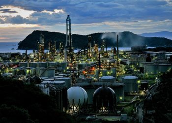 Night view of industrial refinery with bright lights.