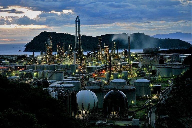 Night view of industrial refinery with bright lights.
