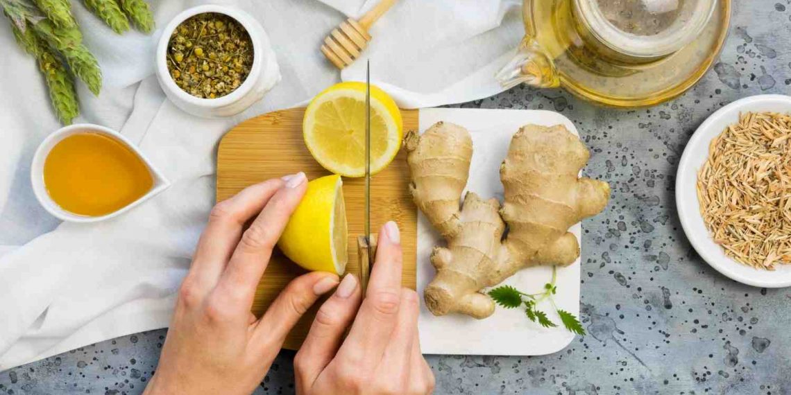 Slicing fresh lemon and ginger for herbal tea preparation.
