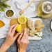 Slicing fresh lemon and ginger for herbal tea preparation.