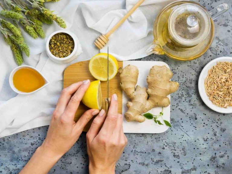 Slicing fresh lemon and ginger for herbal tea preparation.