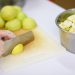 Chopping fresh guavas on a cutting board for a fruit salad.