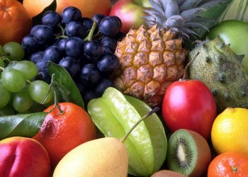 Assorted tropical fruits, including pineapple and kiwi.