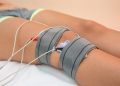 Electrode therapy on knee for pain relief using electrotherapy.