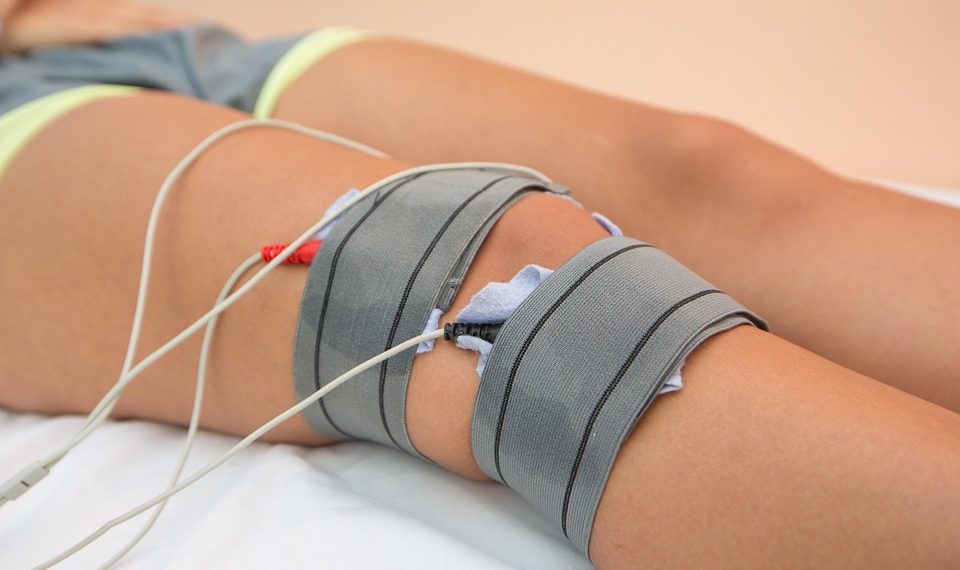 Electrode therapy on knee for pain relief using electrotherapy.