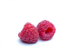 Two fresh raspberries on a white background.