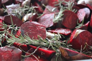 Roasted beet slices with fresh rosemary sprigs.