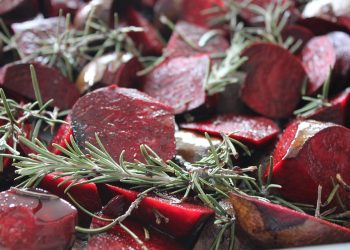 Roasted beet slices with fresh rosemary sprigs.
