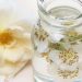 Jar of floral-infused water with rose petals.