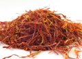 Dried saffron strands on white surface.
