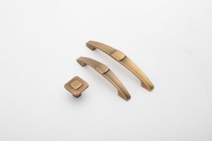 Bronze cabinet handles and knob displayed on white background.