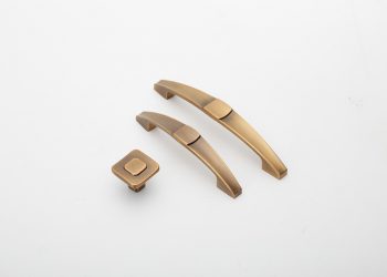 Bronze cabinet handles and knob displayed on white background.