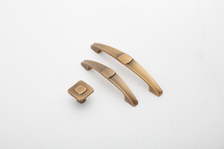 Bronze cabinet handles and knob displayed on white background.