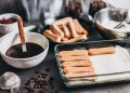 Tiramisu ingredients ready for assembly with coffee and ladyfingers.