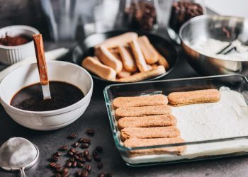 Tiramisu ingredients ready for assembly with coffee and ladyfingers.
