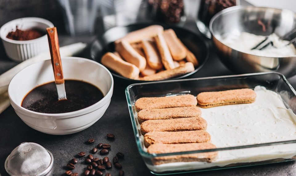 Tiramisu ingredients ready for assembly with coffee and ladyfingers.