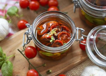 Sun-dried tomatoes preserved in olive oil in a glass jar.