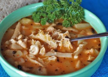 Hearty tripe soup in a bowl garnished with fresh parsley.