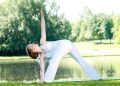 Woman practicing outdoor yoga in a park.