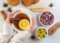 Cozy herbal tea with lemon and cinnamon, accompanied by dried flowers and cookies.