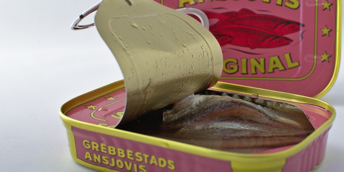 Open can of Grebbestads anchovies showing fish fillets inside.