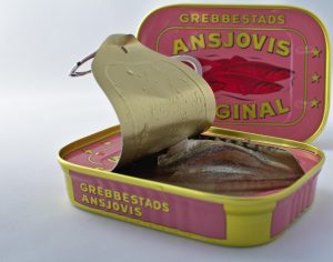 Open can of Grebbestads anchovies showing fish fillets inside.