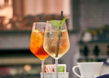 Refreshing cocktails with mint garnish served outdoors.