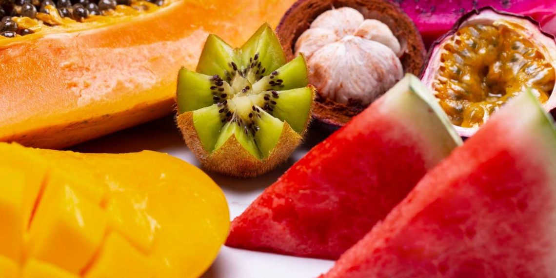 Tropical fruit assortment with kiwi, watermelon, and papaya.