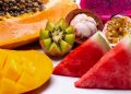 Tropical fruit assortment with kiwi, watermelon, and papaya.