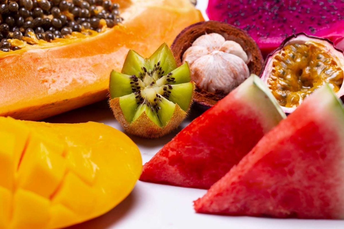 Tropical fruit assortment with kiwi, watermelon, and papaya.