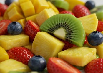 Tropical fruit salad with kiwi, strawberries, blueberries, and pineapple cubes.