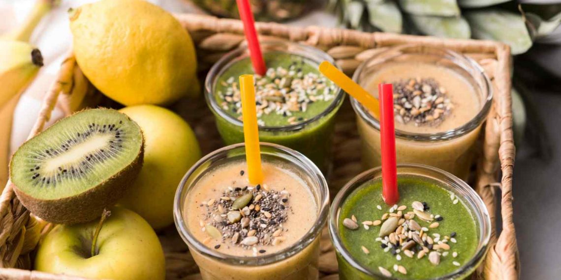 Smoothies with seeds and fresh fruit in a basket