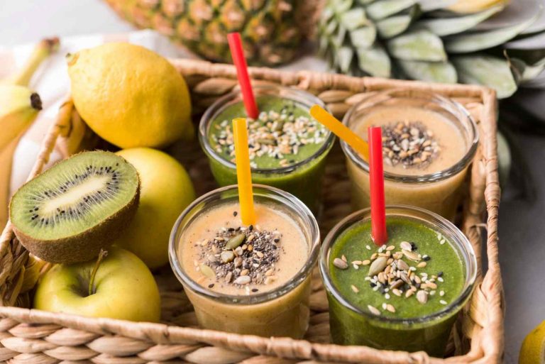 Smoothies with seeds and fresh fruit in a basket