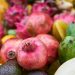 Assorted fresh tropical fruits including pomegranates and dragon fruits.