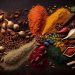 Assorted vibrant spices arranged on a dark surface.