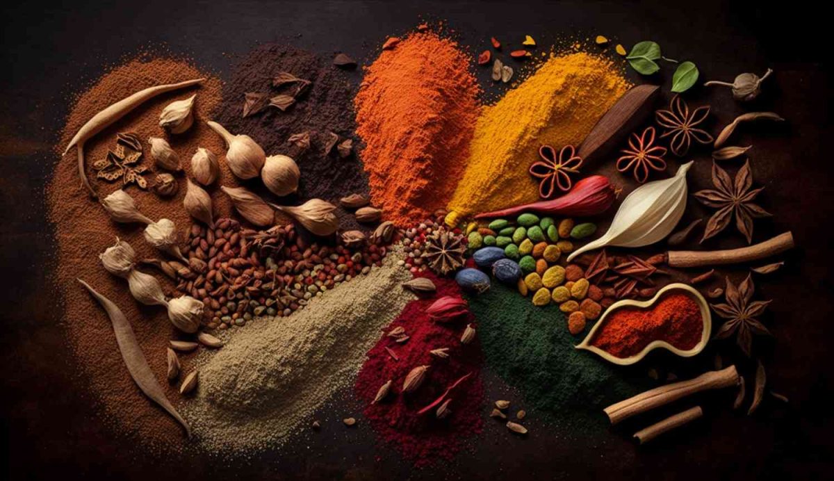 Assorted vibrant spices arranged on a dark surface.