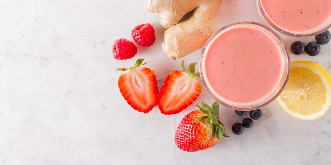 Smoothie with strawberries, ginger, lemon, raspberries, and blueberries.