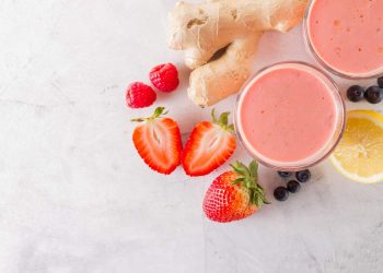 Smoothie with strawberries, ginger, lemon, raspberries, and blueberries.