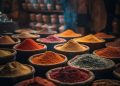 Baskets of colorful spices in a market stall.