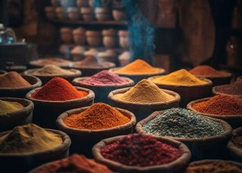 Baskets of colorful spices in a market stall.