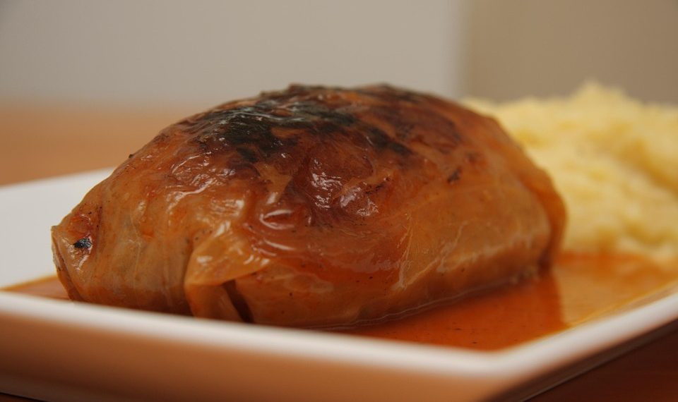 Stuffed cabbage roll served with mashed potatoes.