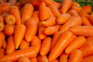 Fresh carrots piled in a market.