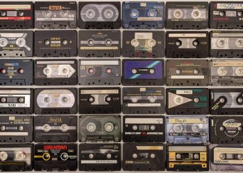 Vintage cassette tapes organized in rows, showcasing various brands and styles.