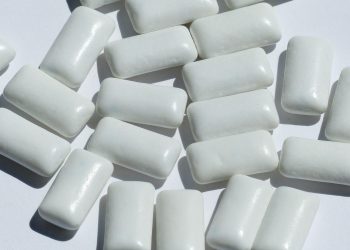 Chewing gum pieces scattered on a white surface.