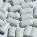 Chewing gum pieces scattered on a white surface.